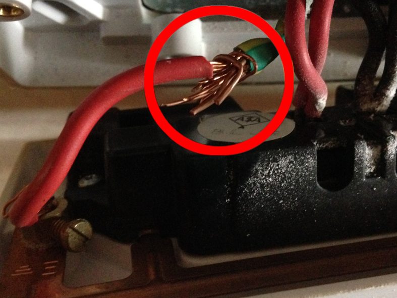 Loose bare copper conductor found in an accessory